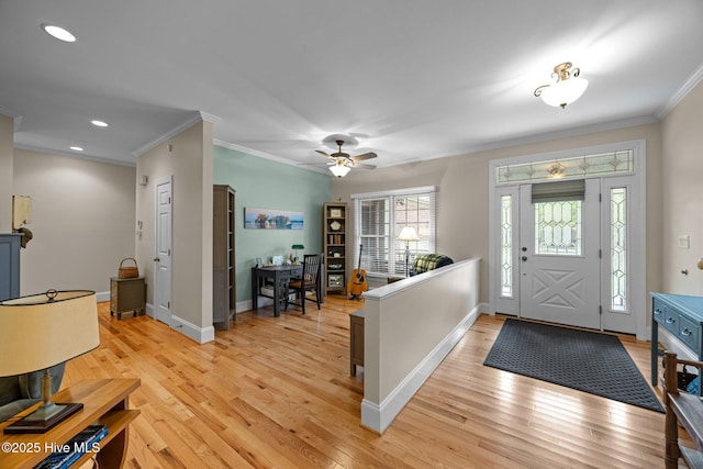foyer featuring baseboards, light wood-style floors, ceiling fan, and crown molding