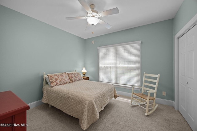 carpeted bedroom with a ceiling fan, baseboards, and a closet