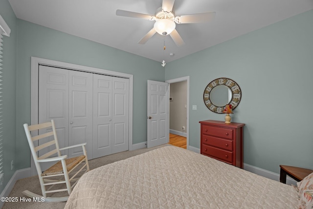 carpeted bedroom with a closet, a ceiling fan, and baseboards