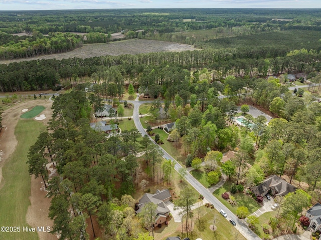 bird's eye view featuring a wooded view