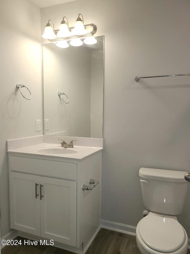 460 Maides Ave, Wilmington, NC 28405 - half bathroom featuring toilet, wood finished floors, vanity, and baseboards