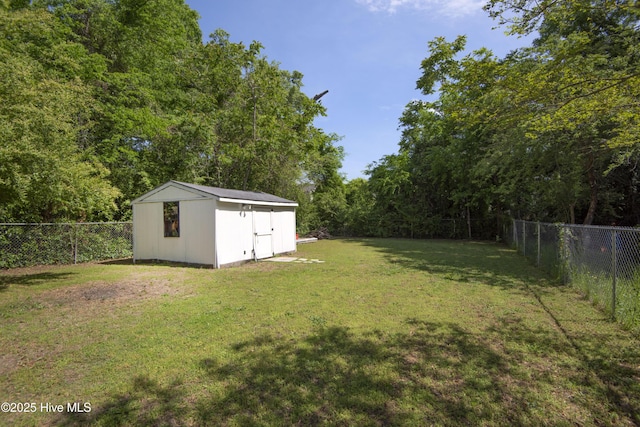915 Saint David St, Tarboro, NC 27886 - view of yard with a storage shed, a view of trees, a fenced backyard, and an outdoor structure