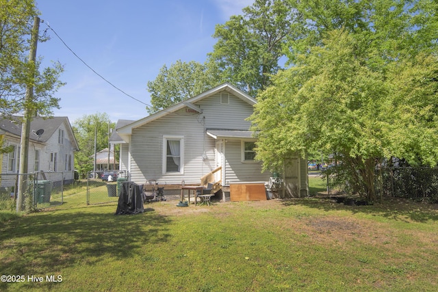 915 Saint David St, Tarboro, NC 27886 - back of house with a fenced backyard, entry steps, and a yard