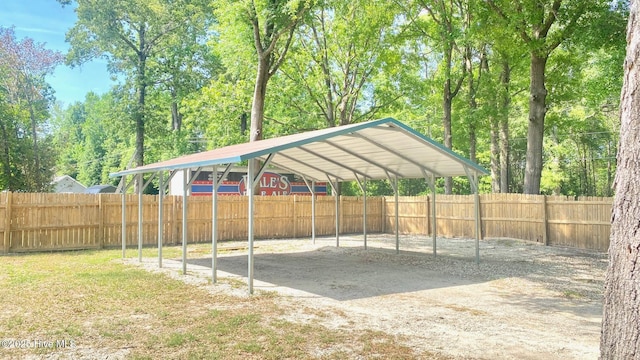 3772 Old Maco Rd NE, Leland, NC 28451 - view of car parking with dirt driveway, fence, and a carport