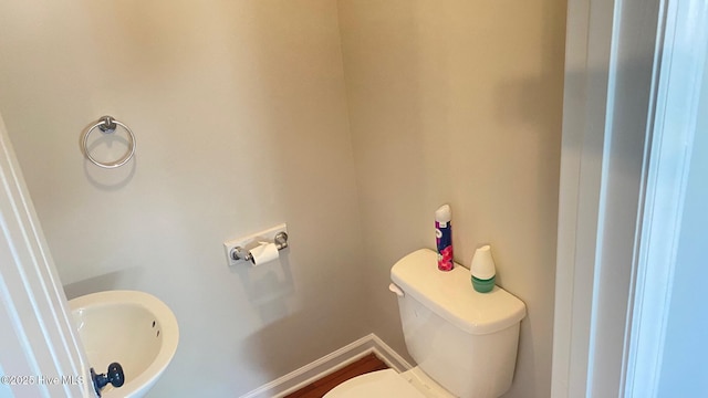 3772 Old Maco Rd NE, Leland, NC 28451 - half bathroom with toilet, baseboards, and a sink