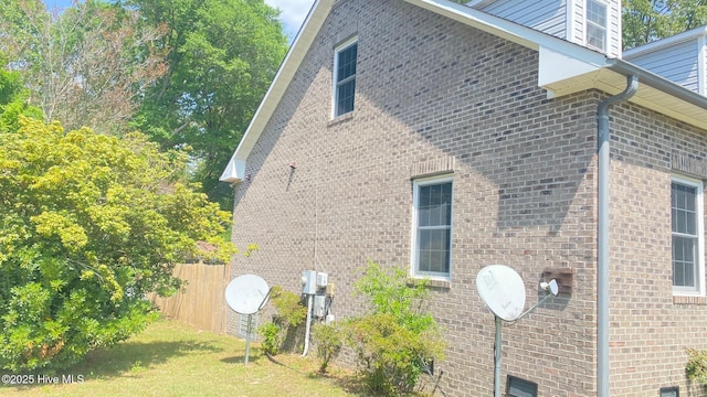 3772 Old Maco Rd NE, Leland, NC 28451 - view of side of property with a lawn, brick siding, and fence