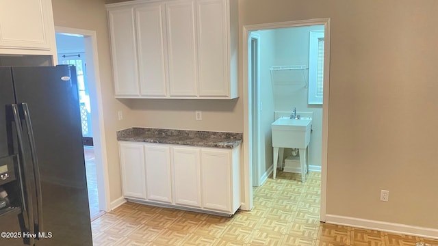 3772 Old Maco Rd NE, Leland, NC 28451 - kitchen with stainless steel fridge with ice dispenser, white cabinets, and baseboards