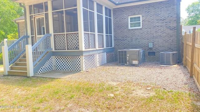 3772 Old Maco Rd NE, Leland, NC 28451 - back of property with brick siding, central AC, a sunroom, and fence