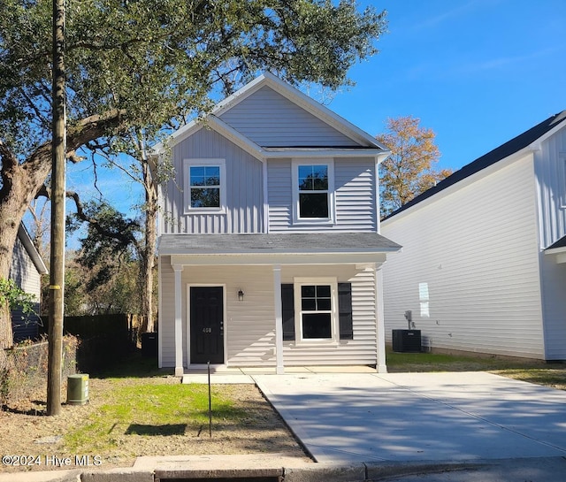 view of front of home with board and batten siding, covered porch, and central AC unit