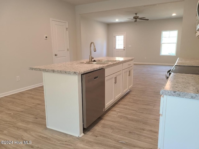 kitchen with white cabinets, light wood finished floors, dishwasher, and a sink