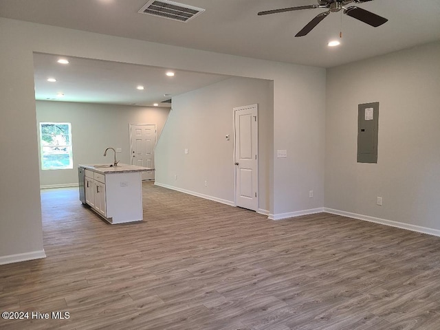 interior space with visible vents, electric panel, a sink, recessed lighting, and wood finished floors