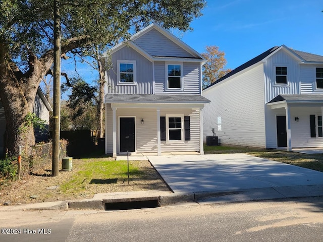 traditional-style home featuring board and batten siding and central AC unit
