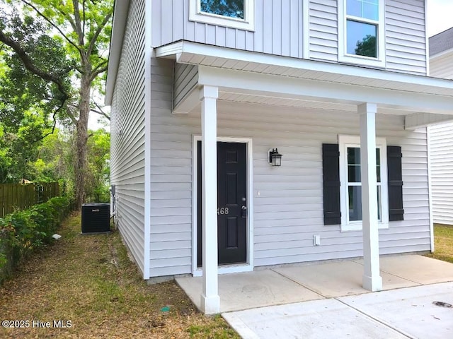 468 Maides Ave, Wilmington, NC 28405 - view of exterior entry featuring board and batten siding, central air condition unit, and covered porch