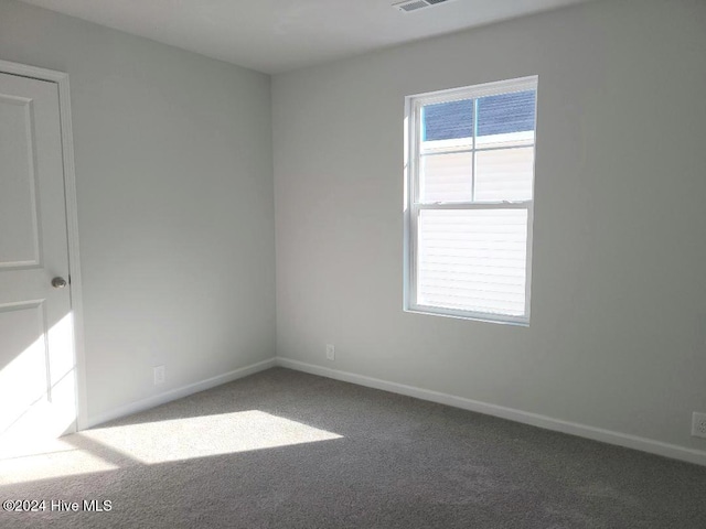 unfurnished room featuring baseboards and carpet