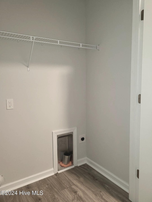 laundry area featuring dark wood-style flooring, baseboards, and hookup for an electric dryer