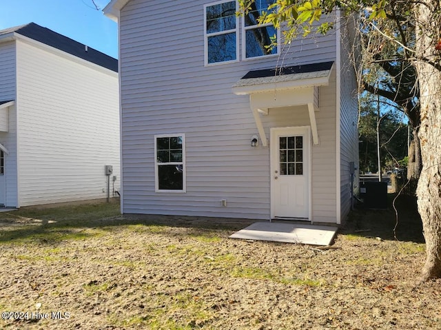 rear view of house featuring central air condition unit