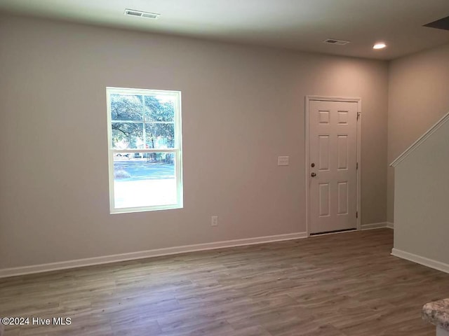 unfurnished room with visible vents, baseboards, recessed lighting, and wood finished floors