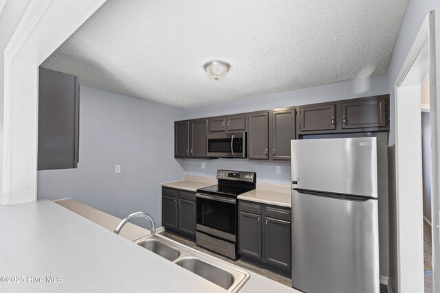 110 Vauhan Ct, Jacksonville, NC 28540 - kitchen featuring a sink, appliances with stainless steel finishes, a textured ceiling, and light countertops
