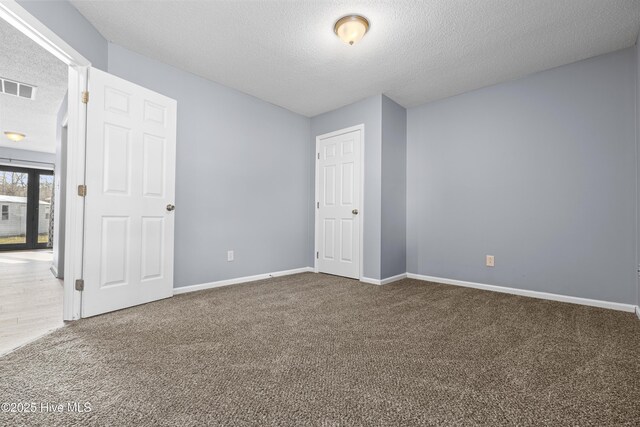 110 Vauhan Ct, Jacksonville, NC 28540 - unfurnished bedroom featuring a textured ceiling, visible vents, carpet flooring, and baseboards