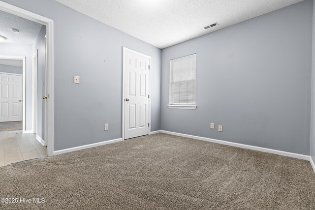 110 Vauhan Ct, Jacksonville, NC 28540 - unfurnished bedroom featuring carpet, baseboards, visible vents, and a textured ceiling