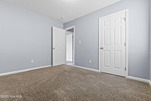 110 Vauhan Ct, Jacksonville, NC 28540 - unfurnished bedroom featuring baseboards, carpet floors, and a textured ceiling