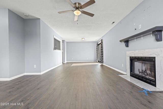 110 Vauhan Ct, Jacksonville, NC 28540 - unfurnished living room with a ceiling fan, wood finished floors, a textured ceiling, a fireplace, and baseboards