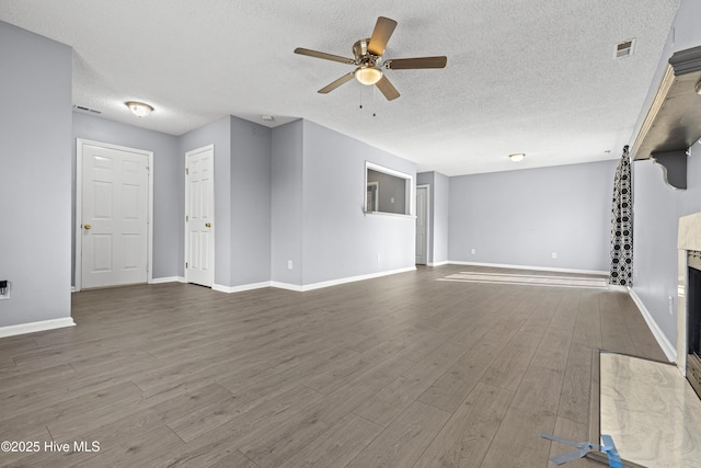 110 Vauhan Ct, Jacksonville, NC 28540 - unfurnished living room with wood finished floors, a textured ceiling, ceiling fan, baseboards, and visible vents