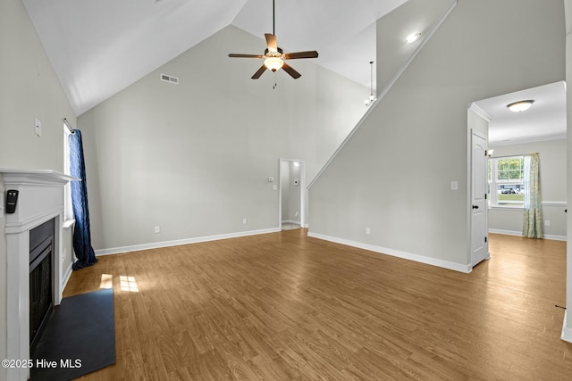 500 Maggies Ct, Jacksonville, NC 28540 - unfurnished living room with high vaulted ceiling, a ceiling fan, light wood-style floors, a fireplace, and visible vents