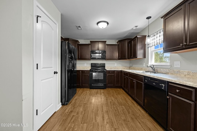 500 Maggies Ct, Jacksonville, NC 28540 - kitchen with light countertops, a sink, dark brown cabinetry, black appliances, and light wood-style flooring