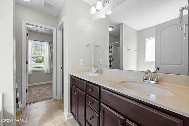 500 Maggies Ct, Jacksonville, NC 28540 - full bath with baseboards, visible vents, a sink, and double vanity