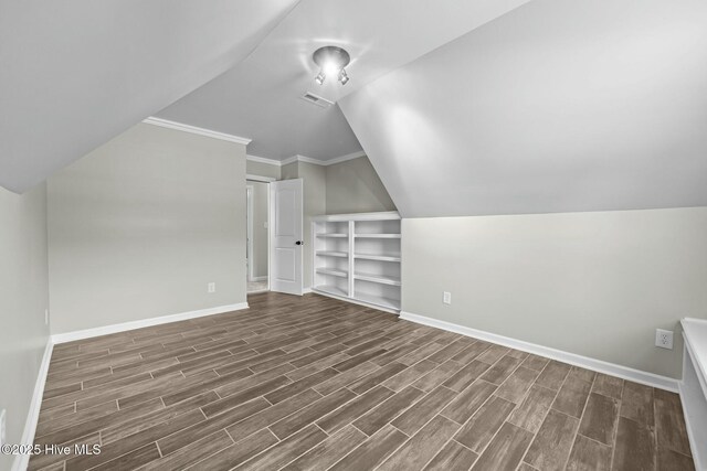 500 Maggies Ct, Jacksonville, NC 28540 - bonus room with vaulted ceiling, baseboards, built in shelves, and dark wood finished floors