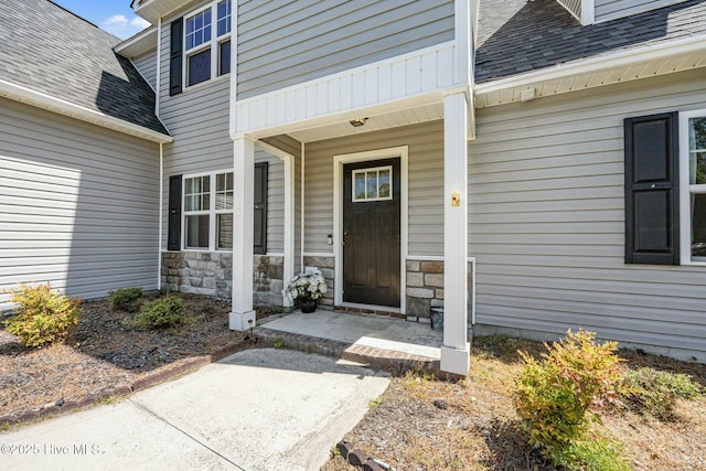 500 Maggies Ct, Jacksonville, NC 28540 - view of exterior entry featuring a porch, a shingled roof, and stone siding