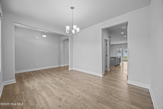 260 E Red Head Cir, Sneads Ferry, NC 28460 - unfurnished dining area with light wood-style floors, baseboards, and a notable chandelier