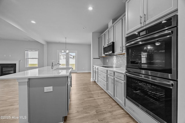 260 E Red Head Cir, Sneads Ferry, NC 28460 - kitchen with stainless steel appliances, light countertops, recessed lighting, and tasteful backsplash