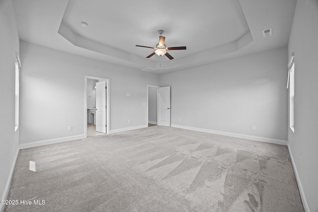 260 E Red Head Cir, Sneads Ferry, NC 28460 - unfurnished bedroom with light carpet, a tray ceiling, visible vents, and baseboards