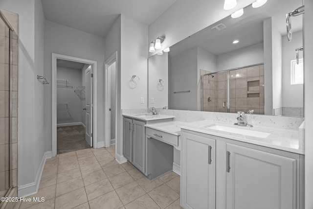 260 E Red Head Cir, Sneads Ferry, NC 28460 - bathroom featuring a sink, a stall shower, a walk in closet, double vanity, and tile patterned flooring