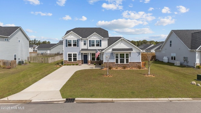 260 E Red Head Cir, Sneads Ferry, NC 28460 - view of front of house featuring concrete driveway, stone siding, a front yard, and fence