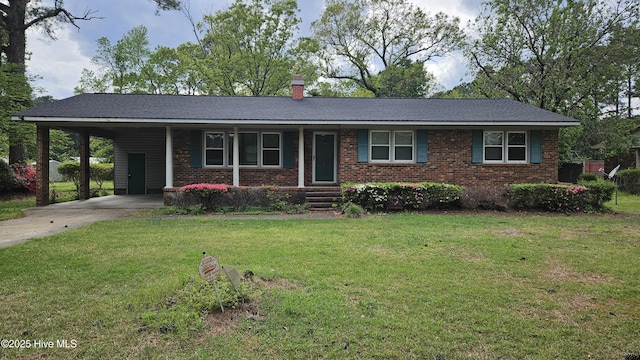 ranch-style house featuring driveway, a chimney, a front yard, and brick siding