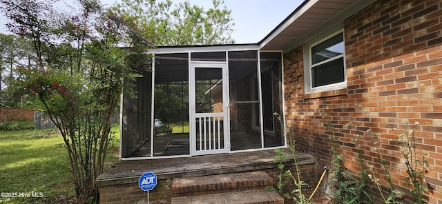 doorway to property with brick siding