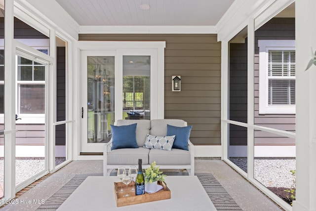 sunroom featuring a wealth of natural light and an outdoor living space