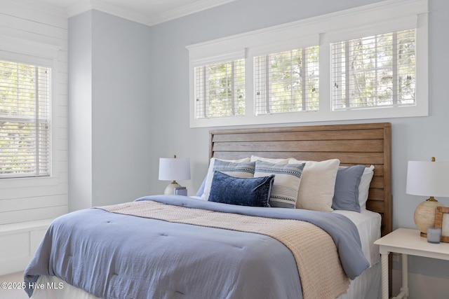 carpeted bedroom featuring crown molding and visible vents