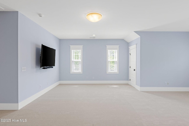 interior space with baseboards, recessed lighting, and light colored carpet