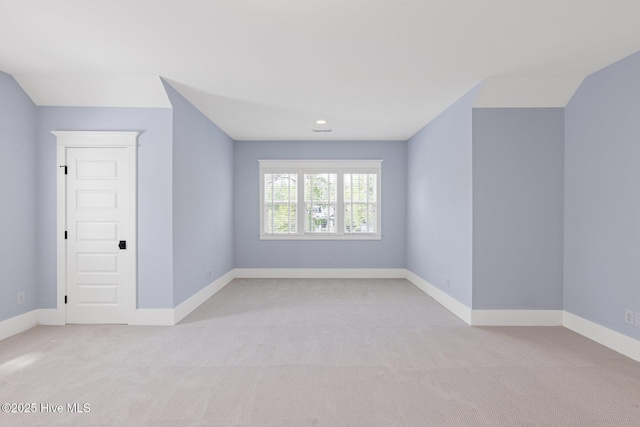 unfurnished living room with light carpet and baseboards
