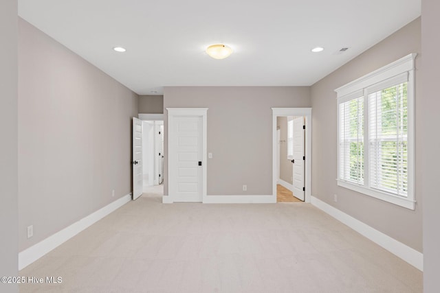 interior space featuring baseboards, recessed lighting, and light colored carpet