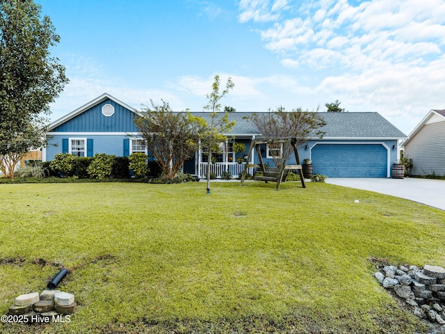 433 Dion Dr, Hubert, NC 28539 - view of front of property with a garage, concrete driveway, a porch, and a front yard