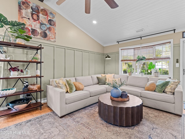 433 Dion Dr, Hubert, NC 28539 - living area featuring visible vents, wainscoting, a decorative wall, lofted ceiling, and ceiling fan