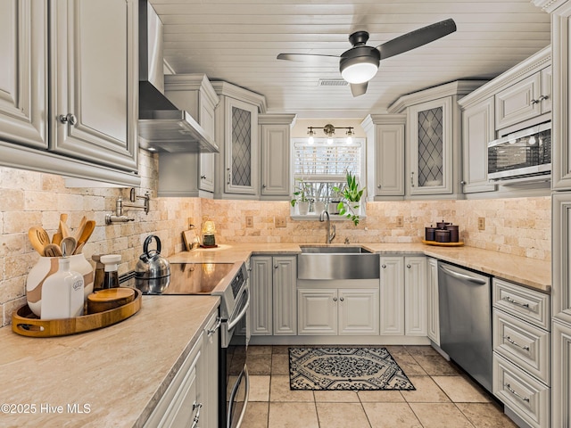 433 Dion Dr, Hubert, NC 28539 - kitchen featuring ceiling fan, wall chimney exhaust hood, tasteful backsplash, a sink, and stainless steel appliances