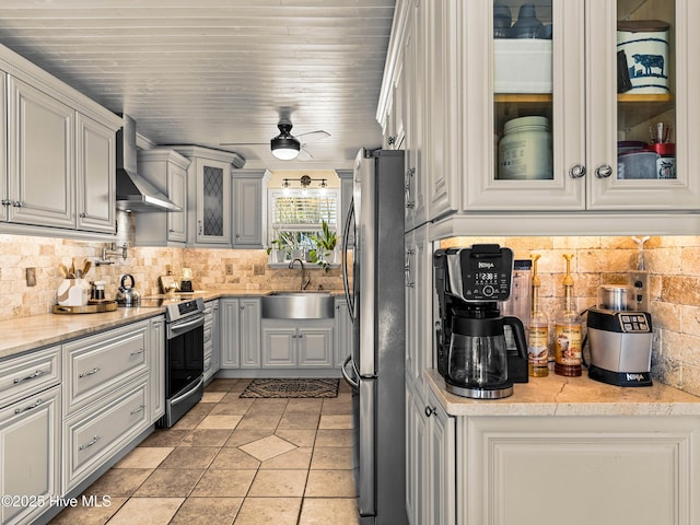 433 Dion Dr, Hubert, NC 28539 - kitchen with wall chimney range hood, decorative backsplash, appliances with stainless steel finishes, a sink, and glass insert cabinets