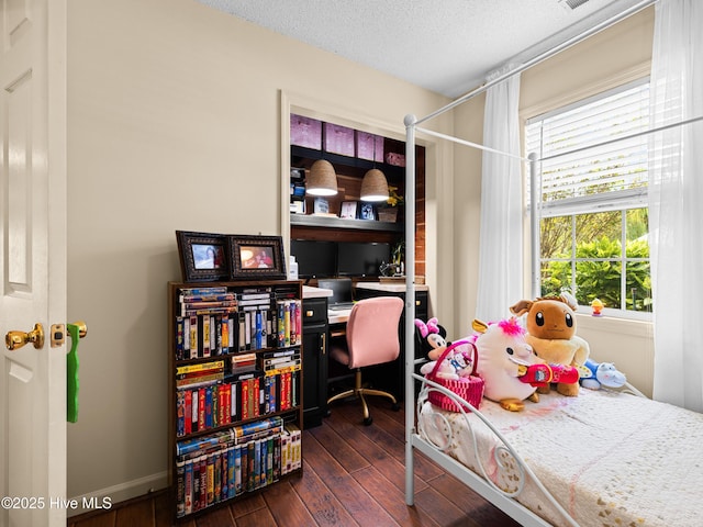 433 Dion Dr, Hubert, NC 28539 - bedroom featuring dark wood-type flooring, a textured ceiling, and multiple windows