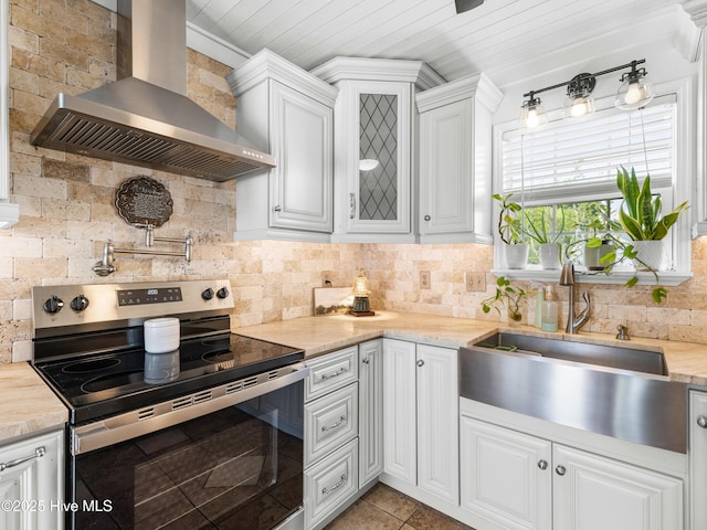 433 Dion Dr, Hubert, NC 28539 - kitchen with stainless steel electric range, wall chimney exhaust hood, a sink, decorative backsplash, and white cabinetry